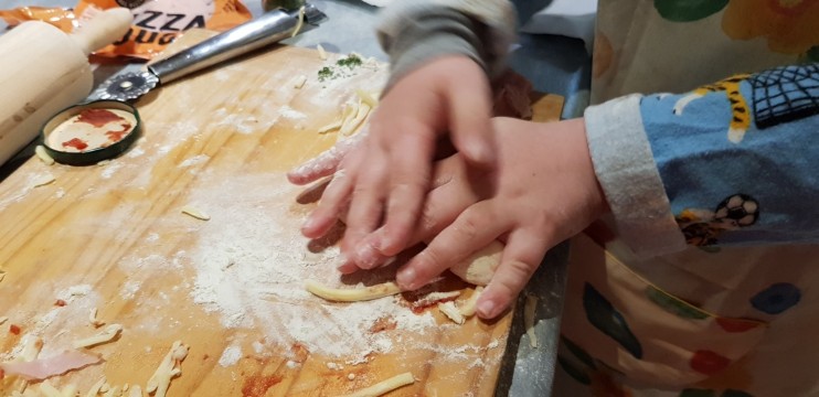 Close up of young child's hands in a cooking class