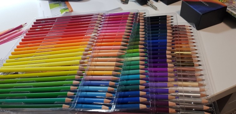 Lots of different coloured pens in a packets looking like a rainbow